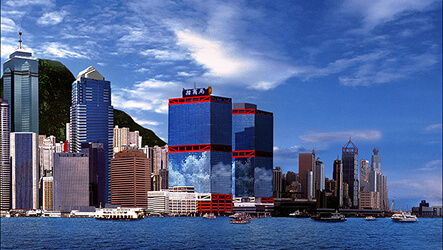 Hong Kong city skyline with modern high-rise buildings and waterfront view.
